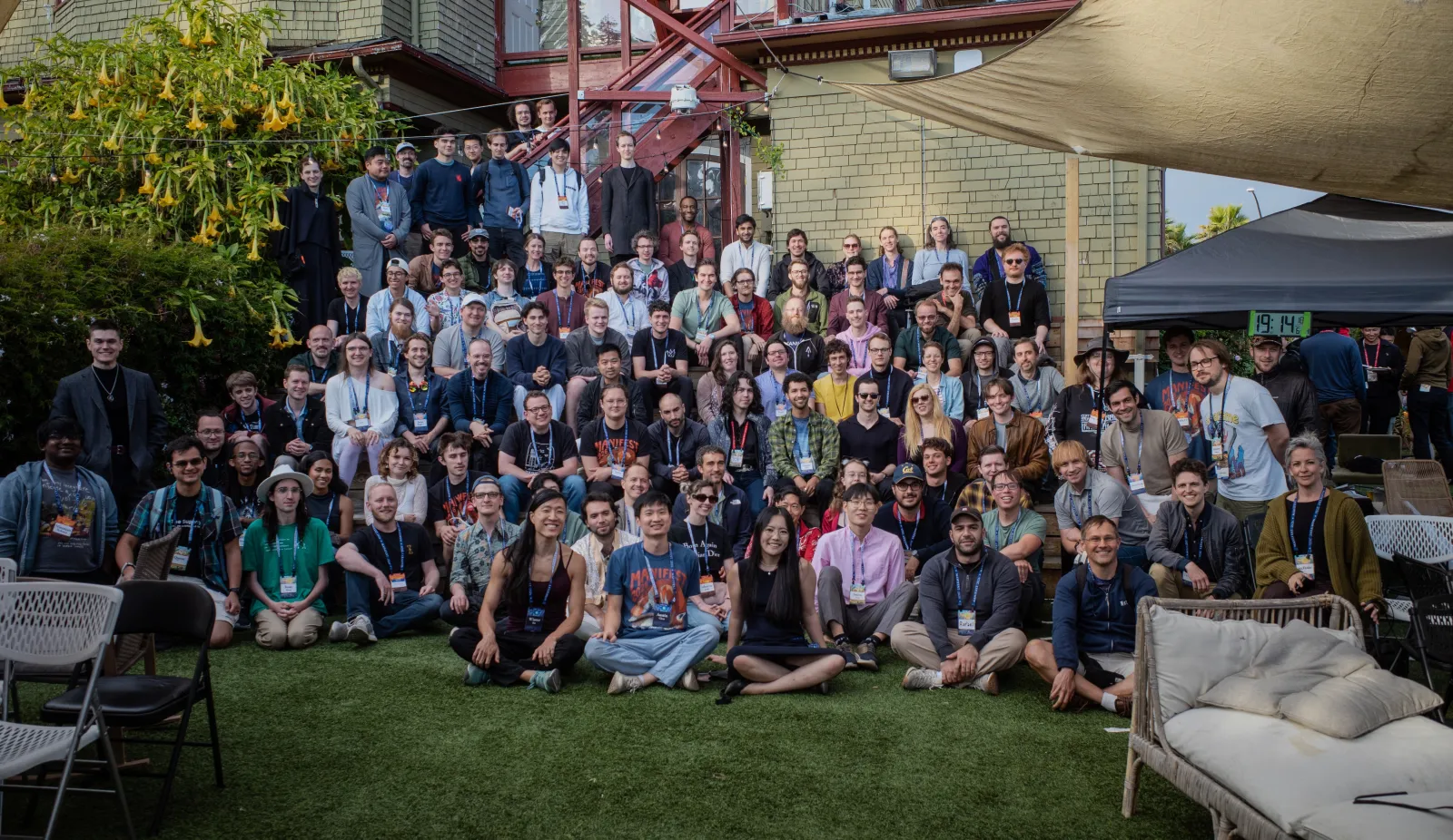 Group photo of Manifest attendees in a backyard