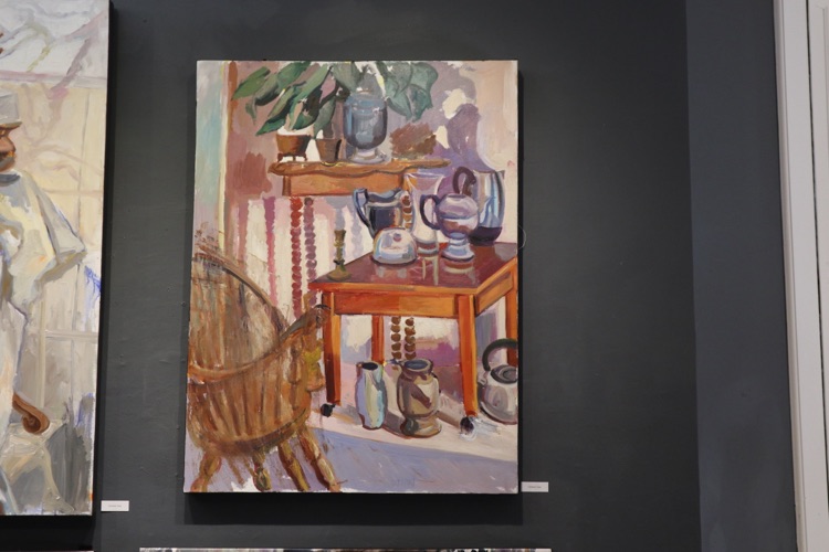 Still life painting hung in a gallery