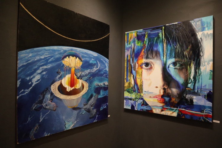 Two paintings hung in a gallery