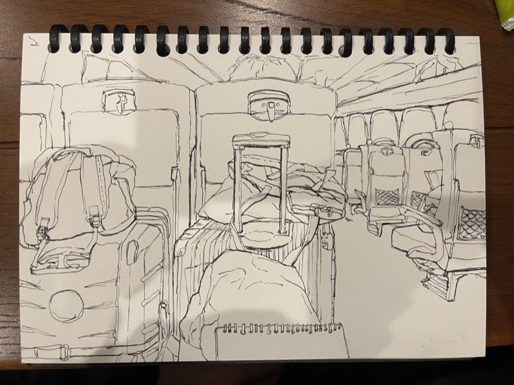 Sketchbook ink drawing of a train interior