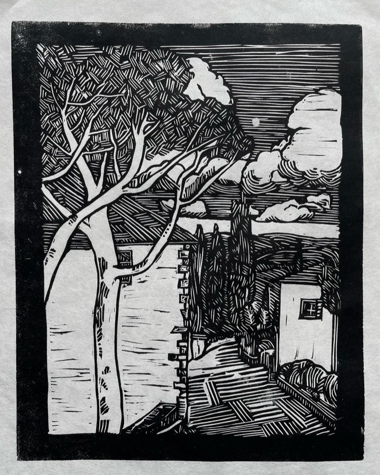 Linocut print of a tree by the water