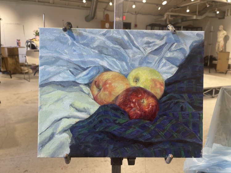 Still life of apples on an easel