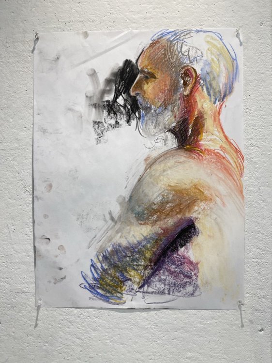 Pastel figure study pinned to a wall