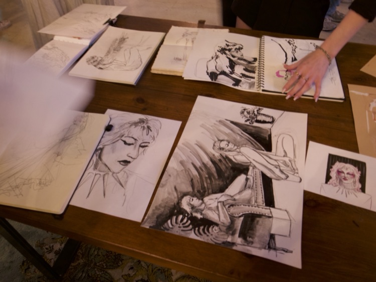 Table of ink sketches and sketchbooks