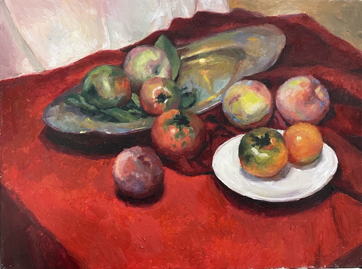 Still life painting of fruit on a red cloth with a tomato on a white plate